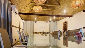 A conference room with a glass table, chairs, and a wooden ceiling with hanging lights. - Ponta Anchaca (Rubane)
