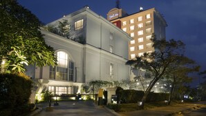A hotel with a grand entrance, multiple floors, and a well-lit facade.
