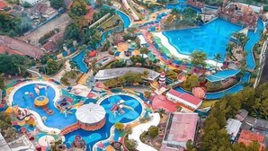 An aerial view of a water park with multiple slides and pools.