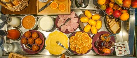 A breakfast buffet with various food items and beverages.