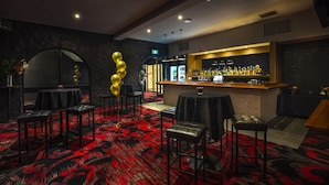 A bar area with a counter, stools, and a red carpeted floor. - Nightcap at Ferntree Gully Hotel Motel (Ferntree Gully)