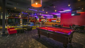A pool table in a room with a bar and seating area. - Nightcap at Matthew Flinders Hotel (Chadstone)