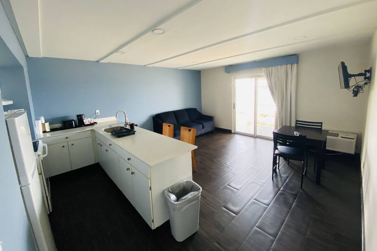 A compact living space with a kitchenette, a dining area, and a seating area.