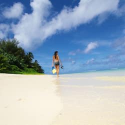 On the beach, white sand, sun-loungers, beach towels