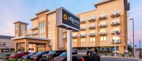 A hotel with a sign reading "La Quinta by Wyndham" and multiple balconies.