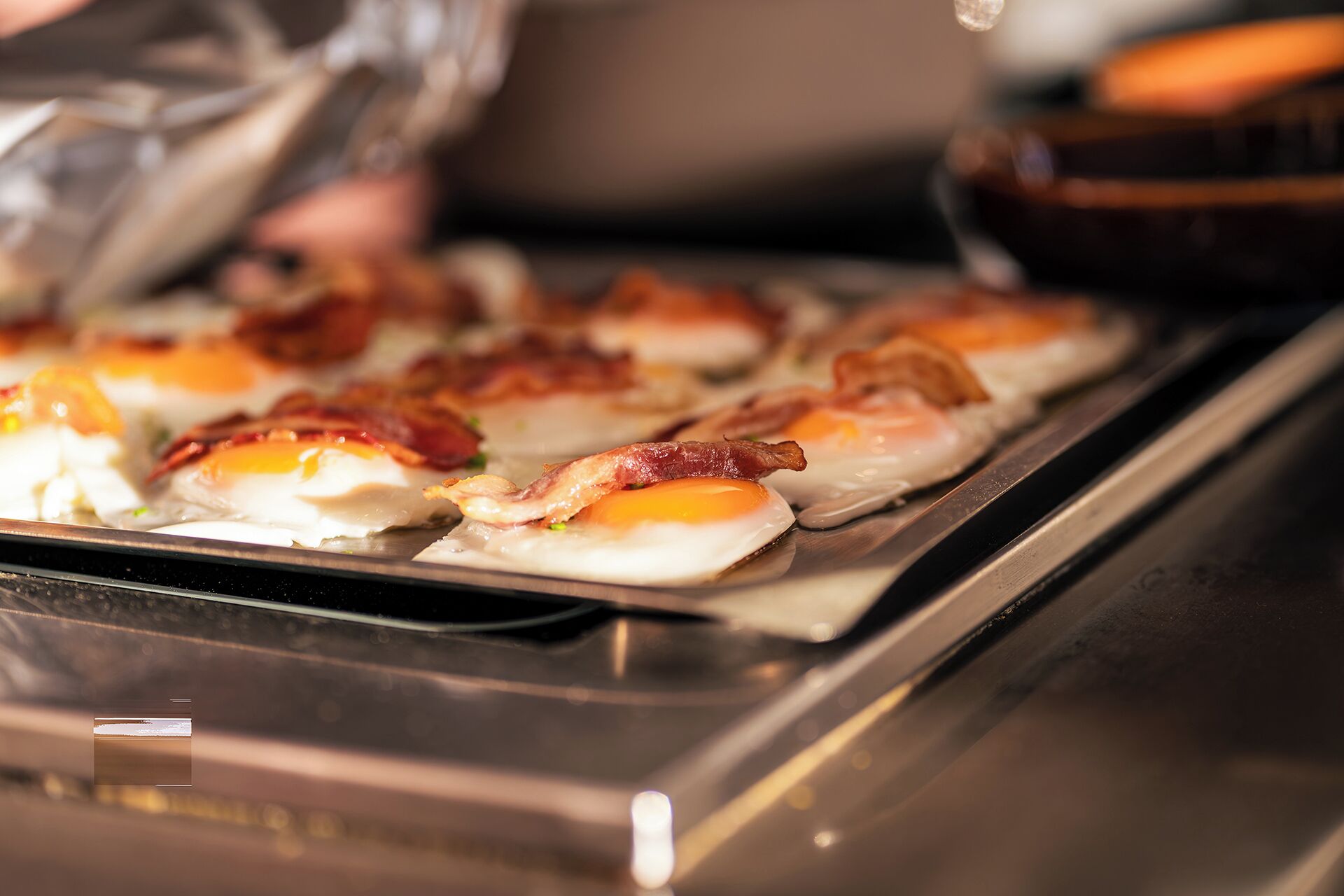 A tray of food items, possibly breakfast, on a metal surface.
