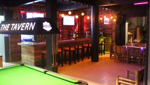 A billiards table, bar area, and seating in a tavern. - Asia Blue The Tavern Hacienda - Hostel (Ko Pha-ngan)