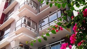 A multi-story building with balconies and large windows. - Hotel La Villa Western (Dhaka)