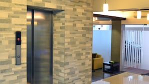 An elevator with a control panel, a patterned wall, and a modern interior design. - Hotel La Villa Western (Dhaka)