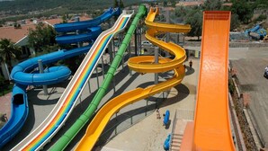 A water park with multiple slides in blue, green, yellow, and orange. - The Grand Üçel Hotel (Fethiye)