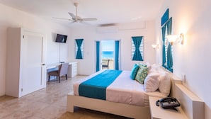 A bedroom with a bed, a desk, a chair, a phone, and a TV. - La Vue Boutique Inn (South Hill)
