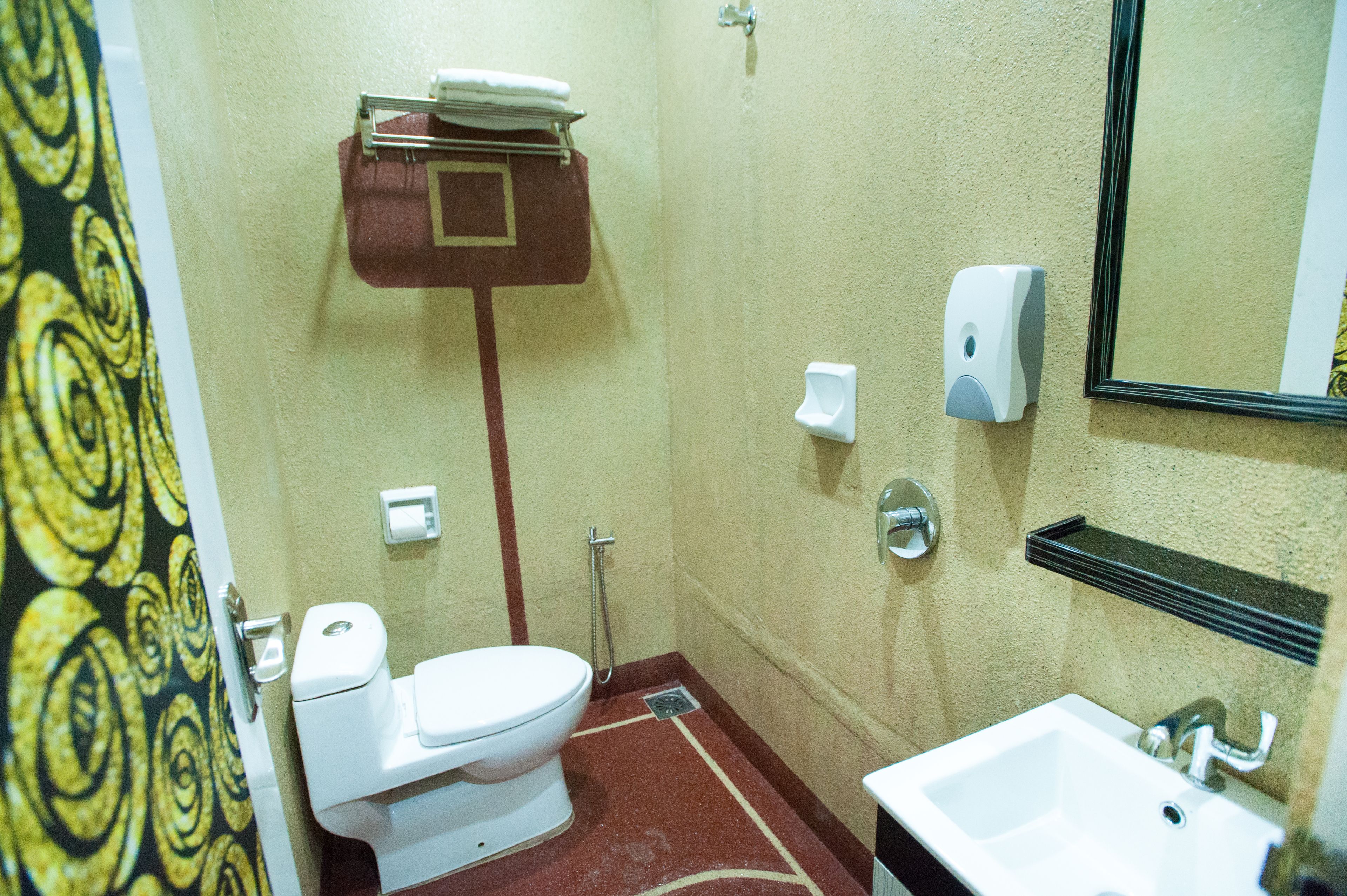 A small bathroom with a toilet, sink, and mirror.