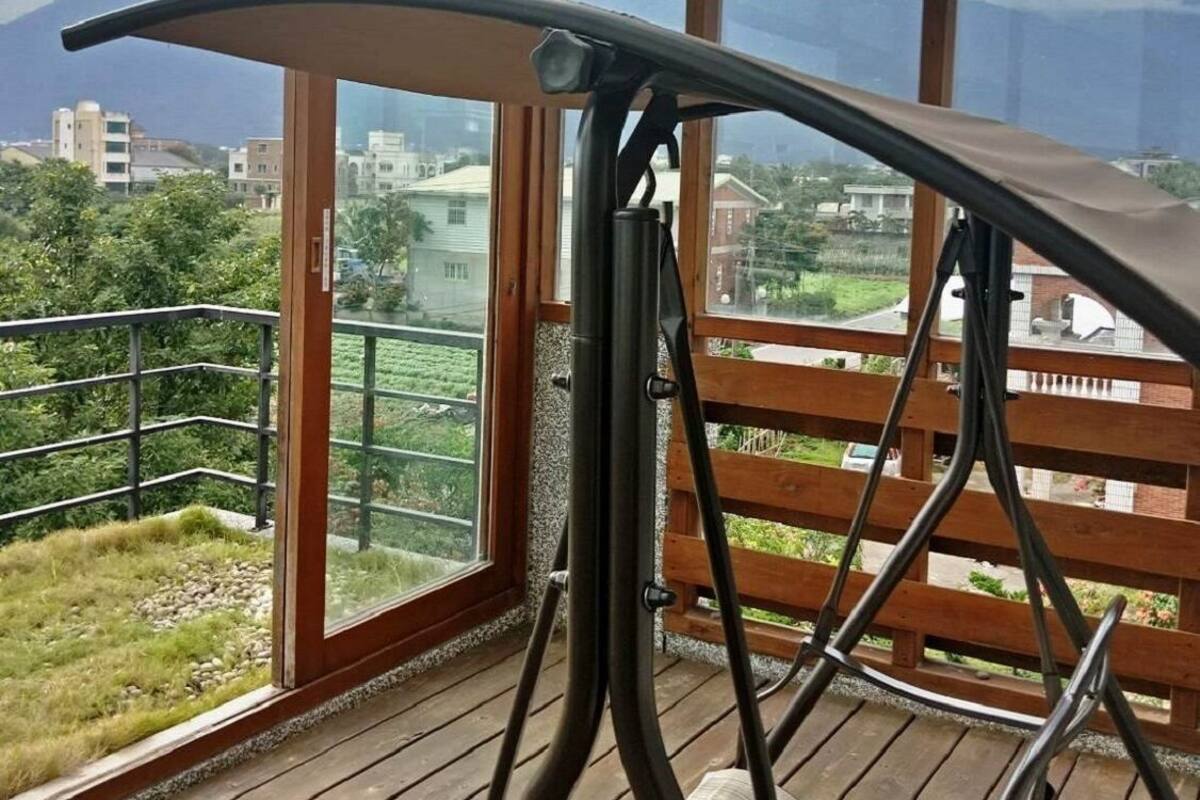 A balcony with a view of a cityscape and mountains.