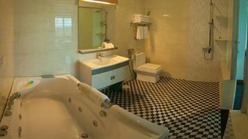 A bathroom with a checkered floor, a bathtub, a sink, a toilet, and a shower.