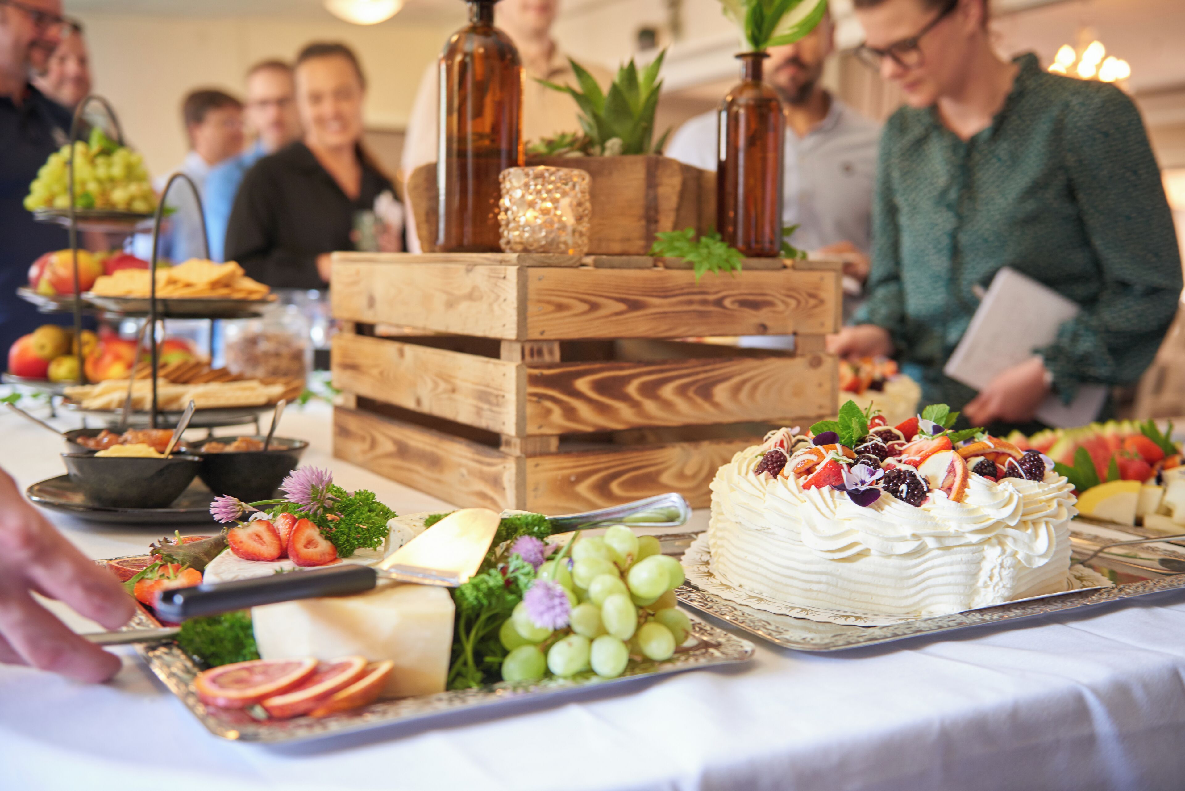 A buffet table with various food items and a cake.