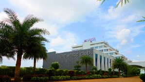 A modern building with a sign reading "the white club." - VW Canyon (Raipur)