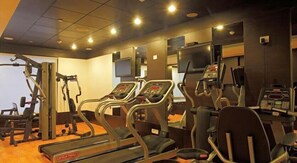 A gym with treadmills, elliptical machines, and weight machines. - SK Premium Park (New Delhi)