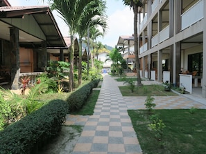 Stroll through the serene courtyard, surrounded by lush greenery and a mix of modern and traditional architecture.