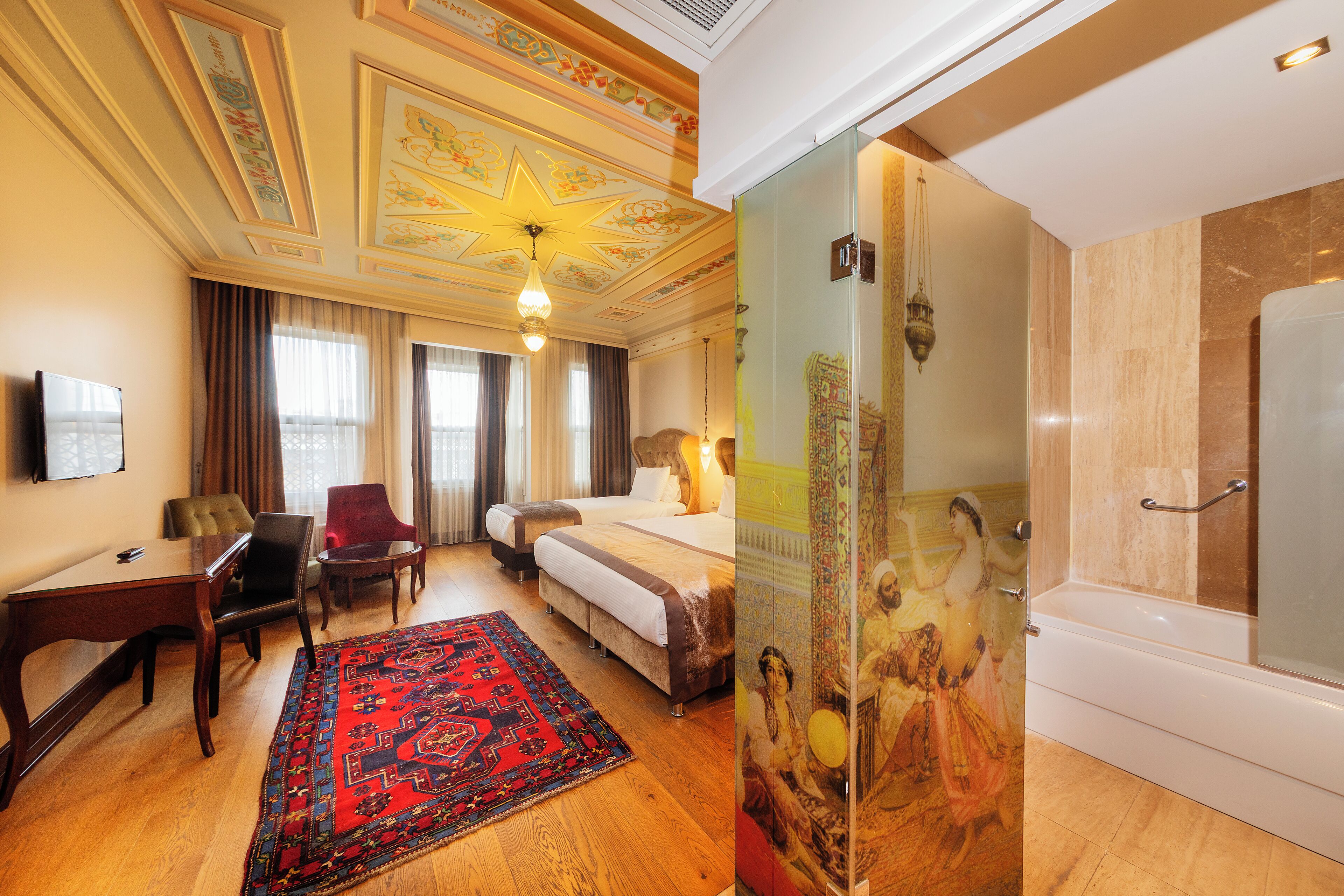 Deluxe Triple Room | Minibar, in-room safe, desk, blackout drapes