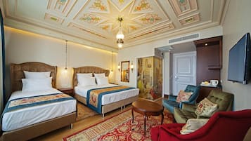 Deluxe Triple Room | Minibar, in-room safe, desk, blackout drapes