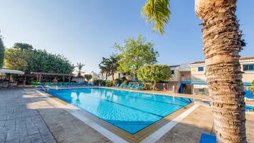 Seasonal outdoor pool, open 8:00 AM to 8:00 PM, pool umbrellas
