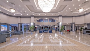 A spacious lobby with a polished marble floor, a grand chandelier, and multiple seating areas. - Meryan Hotel - All Inclusive (Alanya)