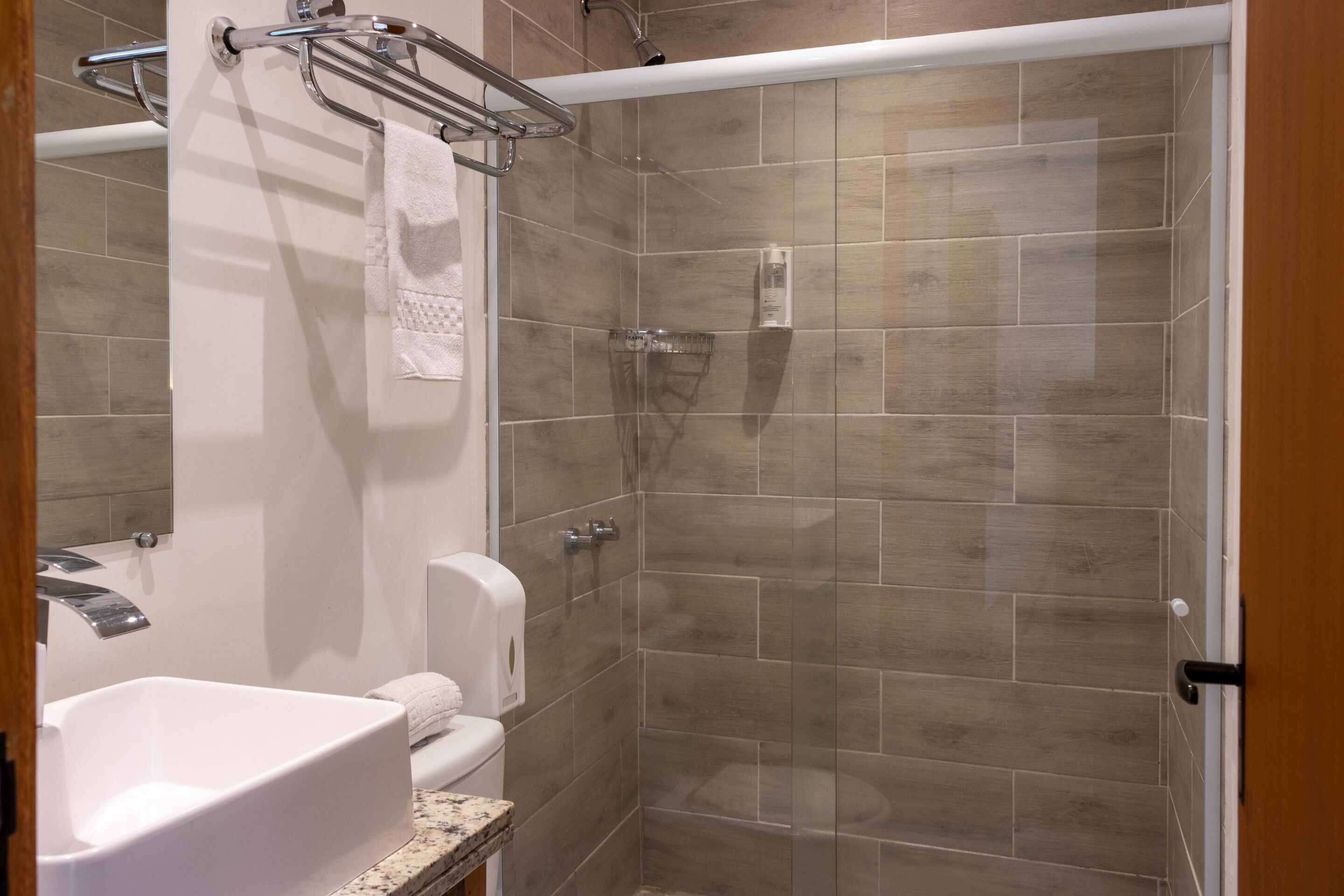 A modern bathroom with a bathtub, a toilet, and a walk-in shower.