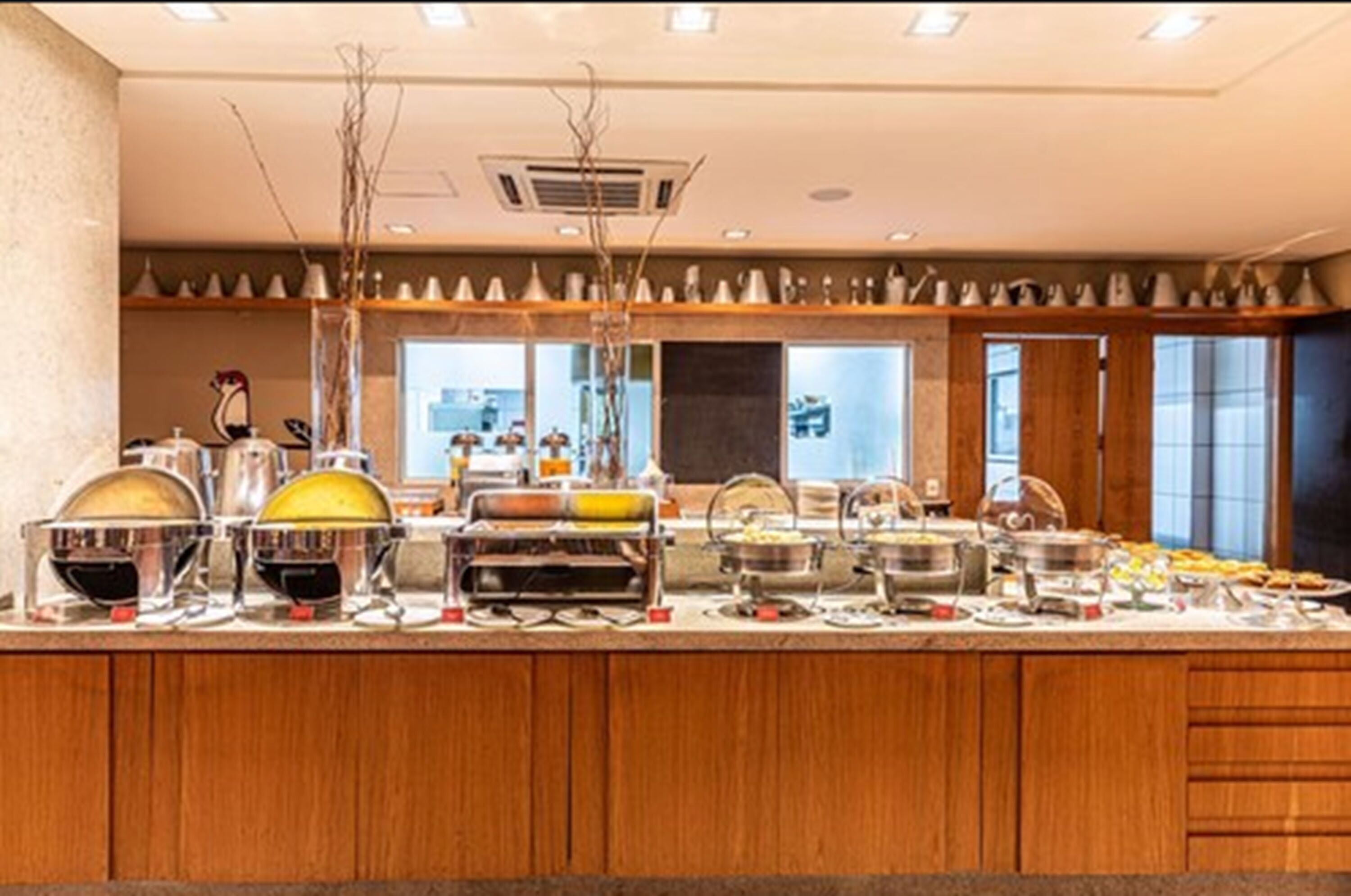 Een buffetopstelling met diverse bakken en bestek.