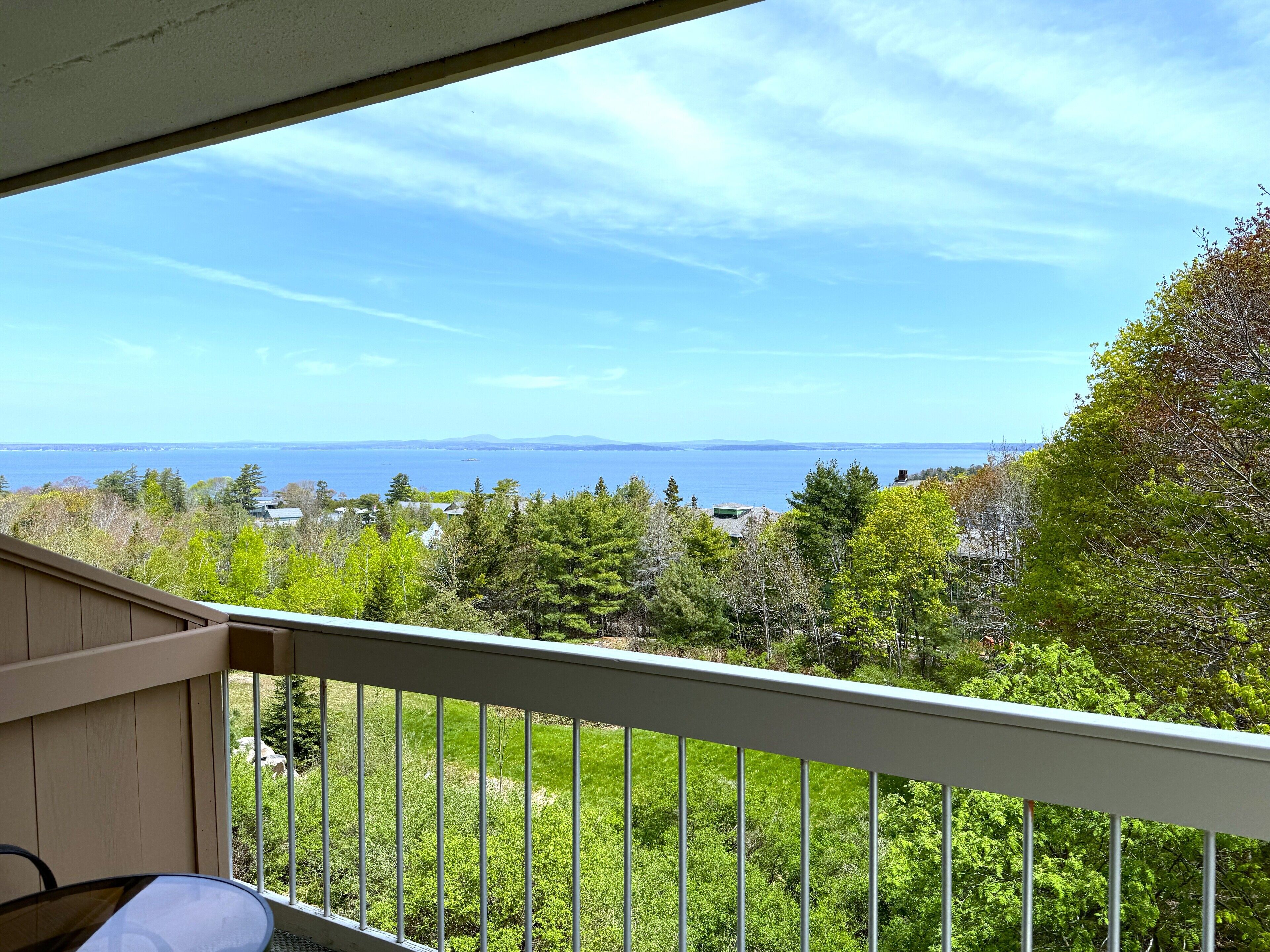 A balcony with a view of a body of water and distant land.