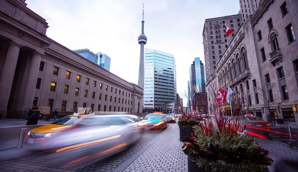 A city street with modern buildings, a prominent tower, and a taxi. - Delta Hotels by Marriott Toronto (Toronto)