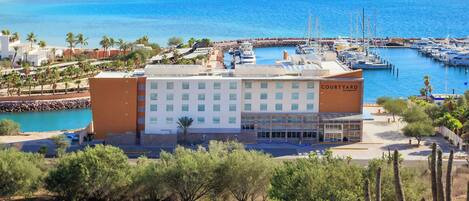A Courtyard hotel with a view of the marina and ocean.