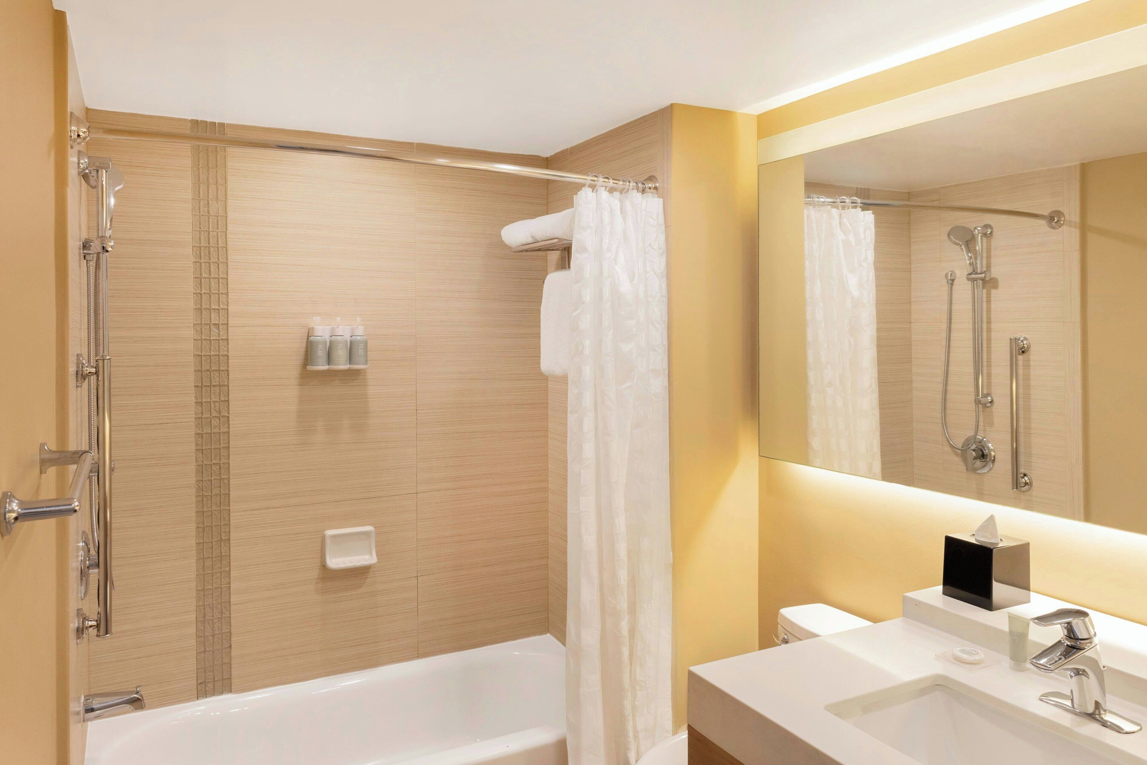 shower, designer toiletries, hair dryer, towels