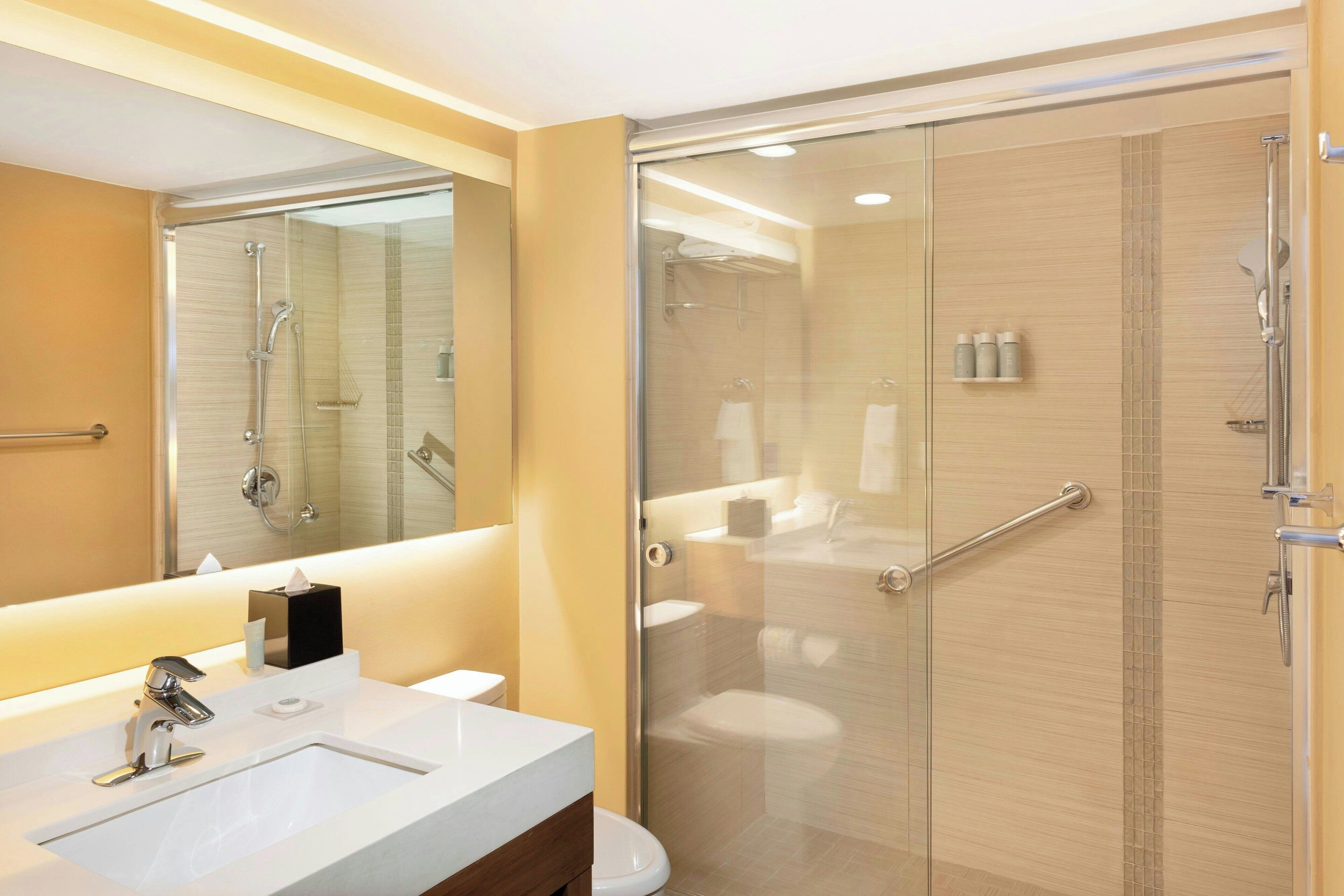 shower, designer toiletries, hair dryer, towels