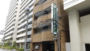 A multi-story building with a sign indicating a business establishment.