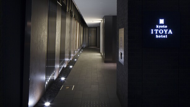 A hallway with a sign for Kyoto ITOYA hotel.