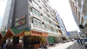 A multi-story building with a restaurant named "EXPA SPORT BAR" on the ground floor. - The Patong Center Hotel (Patong)