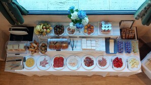 Ein reichhaltiges Buffet mit verschiedenen Speisen und einer Blumenkomposition.
