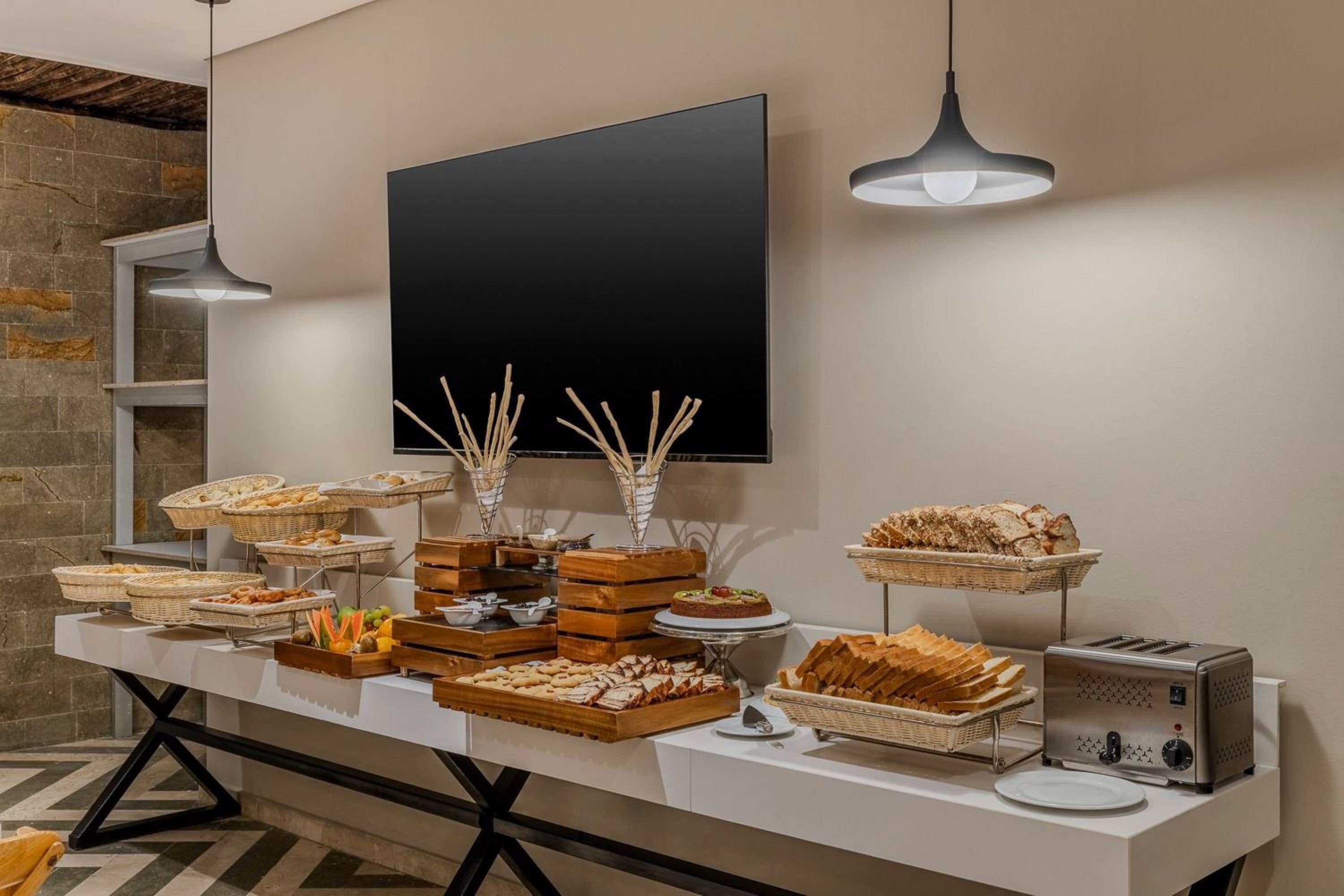 A buffet table with various food items and a toaster.