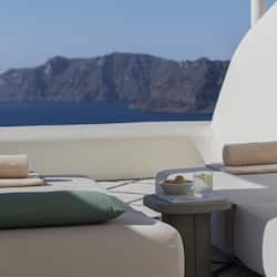 Relax on the balcony with a serene view of the mountains and sea.