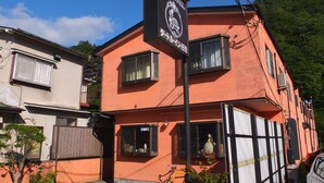 A two-story building with a sign for "Little Inn Mikka" and a bicycle parked outside. - Turtle Inn Nikko (Nikko)