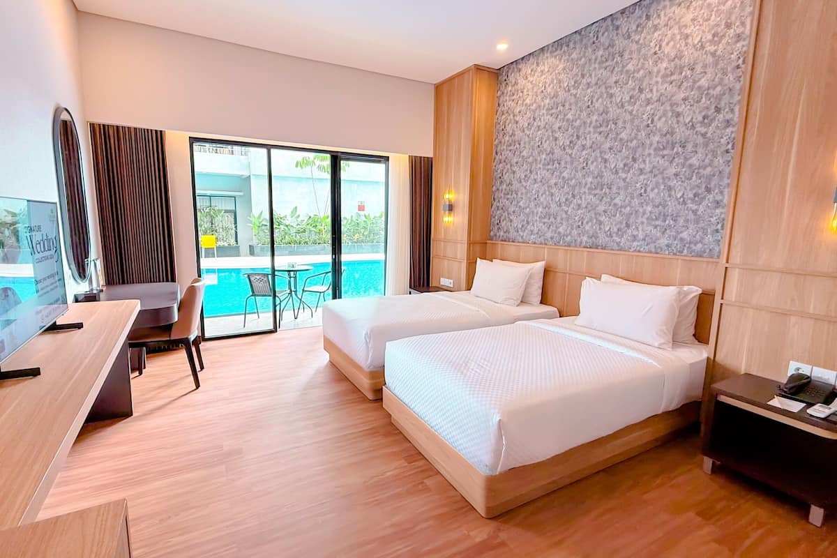 Habitación Deluxe con 1 cama matrimonial o 2 individuales | Artículos del minibar gratis y caja de seguridad en la habitación