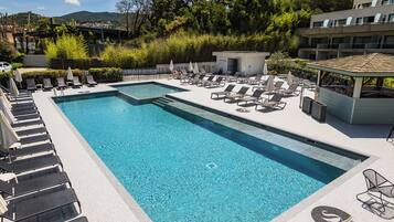 Outdoor pool, open 9:00 AM to 9:00 PM, pool umbrellas, pool loungers