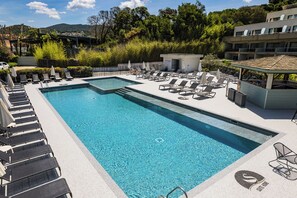 Outdoor pool, open 9:00 AM to 9:00 PM, pool umbrellas, pool loungers