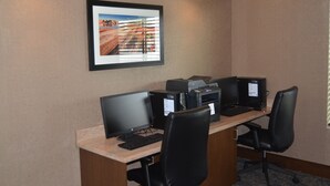 A conference room with a long table, two monitors, a printer, and a framed picture on the wall. - Holiday Inn Express & Suites Springville-South Provo Area by IHG (Springville)