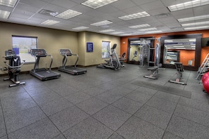 A gym with treadmills, elliptical machines, and weight equipment. - Hampton Inn & Suites Ada (Ada)