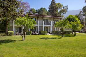 A two-story building with a flat roof, a balcony on the second floor, and a well-maintained lawn with trees. - Sherwood Exclusive Kemer (Kemer)
