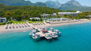 An aerial view of a coastal resort with a pier, beach, and mountain backdrop. - Sherwood Exclusive Kemer (Kemer)