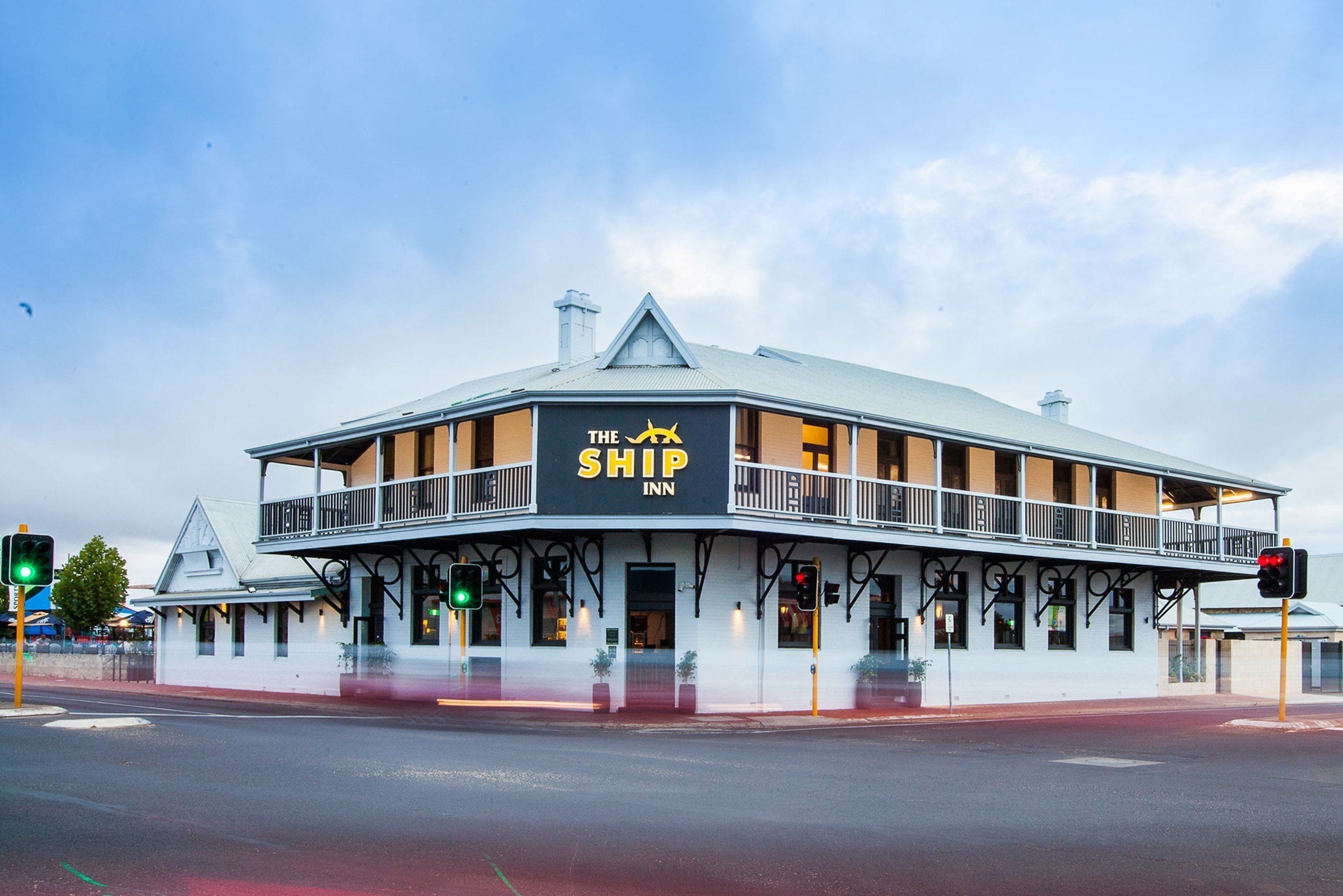 A two-story building with a balcony, labeled "The Ship Inn."