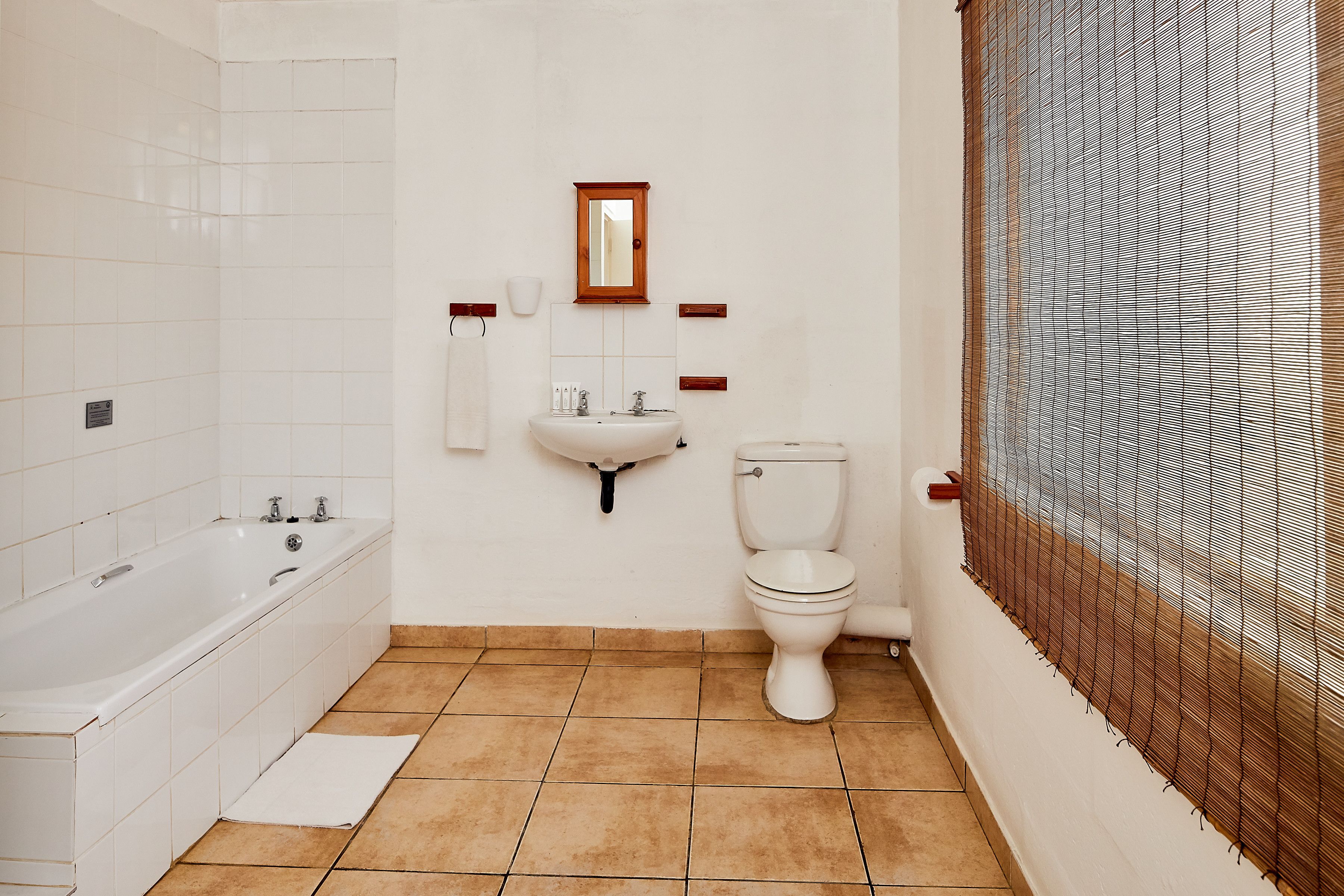 A bathroom with a bathtub, sink, and toilet.