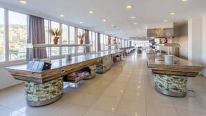 A spacious hotel lobby with a long reception desk, large windows, and a modern kitchen area. - Aslan City Hotel (Alanya)